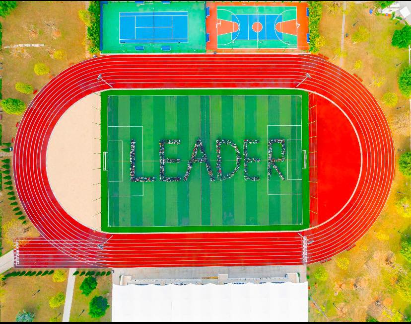 Aerial image spelling leader on a field.